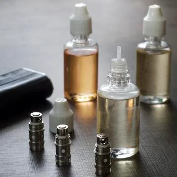 E-cigarettes with lots of different re-fill bottles Stock Photos