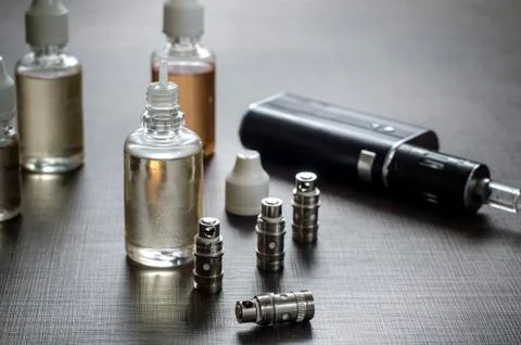 E-cigarettes with lots of different re-fill bottles Stock Photos