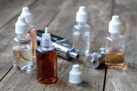 E-cigarettes with lots of different re-fill bottles Stock Photos