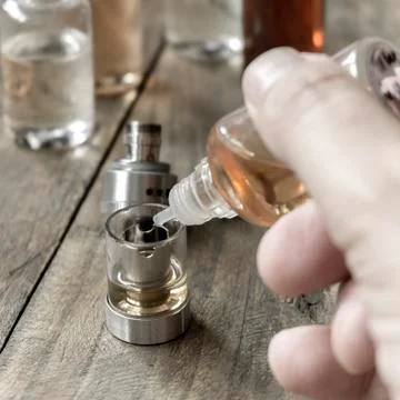 E-cigarettes with lots of different re-fill bottles Stock Photos