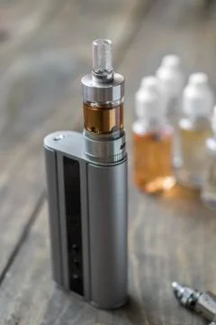E-cigarettes with lots of different re-fill bottles Stock Photos