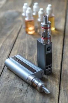 E-cigarettes with lots of different re-fill bottles Stock Photos