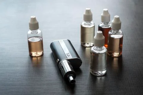 E-cigarettes with lots of different re-fill bottles Stock Photos