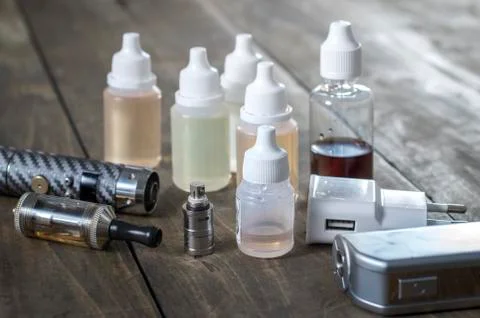 E-cigarettes with lots of different re-fill bottles Stock Photos