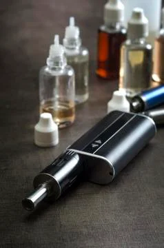 E-cigarettes with lots of different re-fill bottles Stock Photos