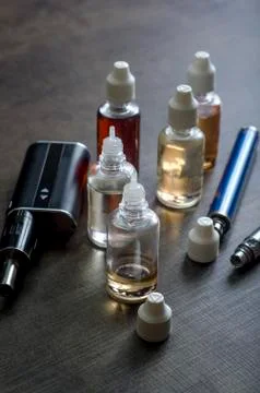 E-cigarettes with lots of different re-fill bottles Stock Photos