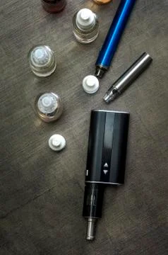E-cigarettes with lots of different re-fill bottles Stock Photos