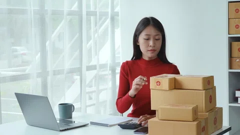 E-commerce, small business, sme , beautiful Asian woman looking at note and Stock Footage 242739034