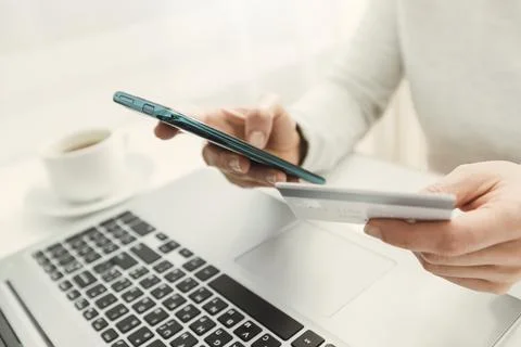  E-commerce. Using a phone and a credit card to buy and pay in an online store.  Stock Photos
