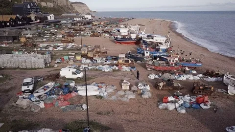 E A couple walk through old fishing beach in Hastings 4K Stock Footage 117593232