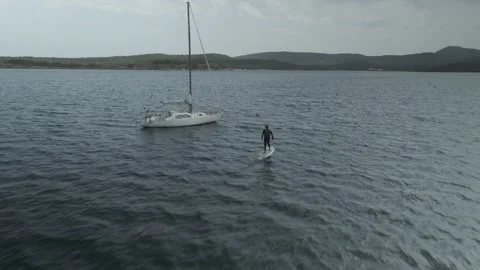 E-Foil Rider Gliding Past a Boat in Menorca, Spain Vídeo Stock 344193356