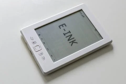 E-ink reader laying flat on a table, displaying the text E-INK Stock Photos