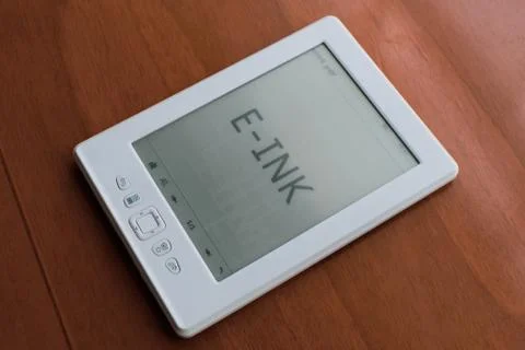 E-ink reader laying flat on a table, displaying the text E-INK Stock Photos