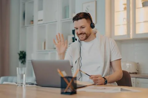 E learning concept. Happy bearded man student has video conference studies Stock Photos
