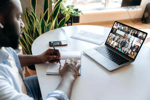E-learning concept, online education. Focused african american guy taking notes 스톡 사진