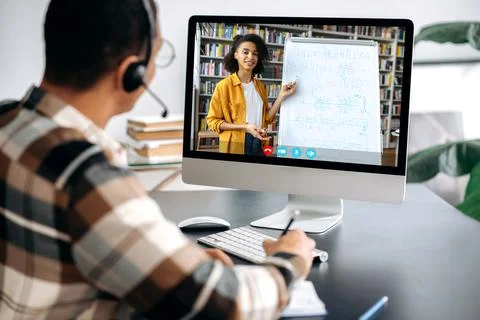 E-learning concept, webinar, online lecture. Over shoulder view of male student Stock Photos