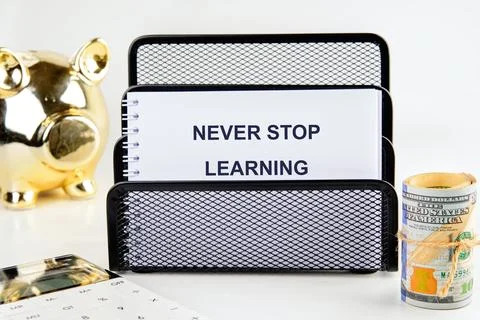E-learning education concept. NEVER STOP LEARNING written message on a blank  Stock Photos