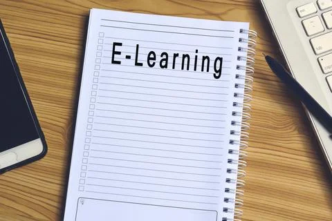 E-learning label on notepad with laptop and smartphone Stock Photos