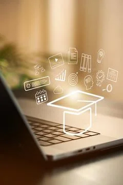 E learning with laptop showing graduation hat and education icons in a workspace Stock Photos