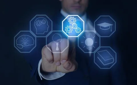 E-learning. Man using virtual screen with different icons on dark backgroun.. Stock Photos