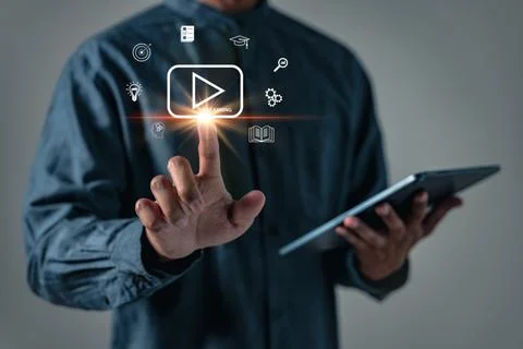 E-learning a person taps a tablet display surrounded by study and idea symb.. 写真素材