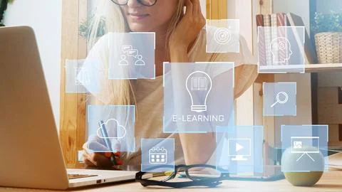 E learning setup with a student working at a computer with digital icons in the Stock Photos