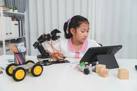 E-learning for STEM: A child learning to code for her robotics project. Stock Photos