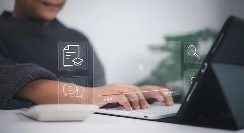 E-learning technology shown as young person types on laptop with virtual ic.. Foto stock