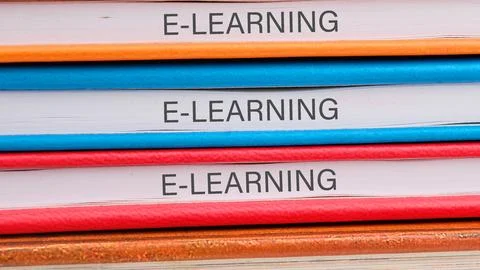 E-LEARNING word on the ends of notebooks lying on top of each other Stock Photos