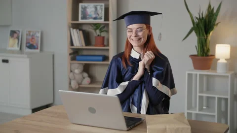 E-learning, young female student happily pulls diploma out of an envelope during Stock Footage 154944694