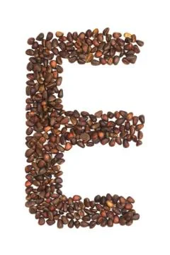 E letter made of cedar  nuts Stock Photos
