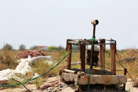 E old rusty mechanism to pull fishing boats on land Stock Photos