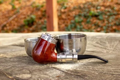 E-pipe with blurred background and cup of coffee in natural ambient Stock Photos