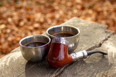 E-pipe with blurred background and cup of coffee in natural ambient Stock Photos
