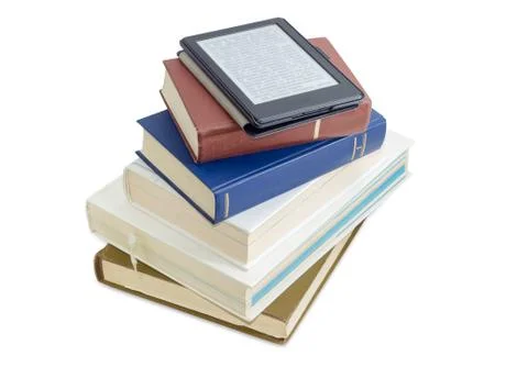 E-reader with blurred text on stack of printed books Stock Photos