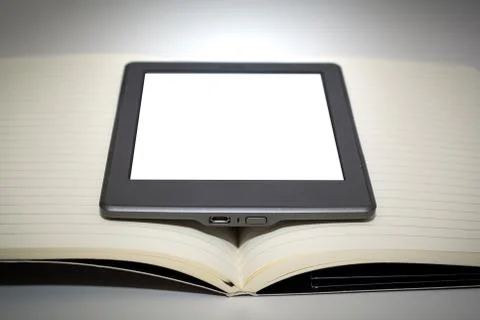 E reader device in the middle of the pages of a blank book Stock Photos