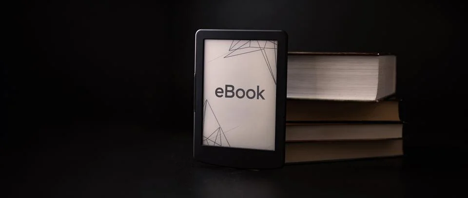 E reader. Digital e book, library reader tablet with books on dark background Stock Photos