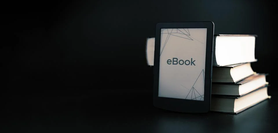 E reader. Digital e book, library reader tablet with books on dark background Stock Photos