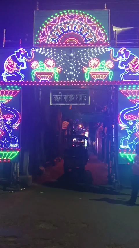 E-Rickshaw Passes Through Colorful LED Festival Gate In Kolkata Stock Footage 337227476