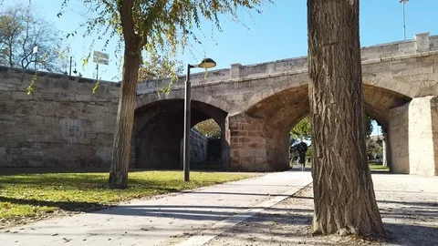 An e-scooter and a runner in a public park Stock Footage 100966182