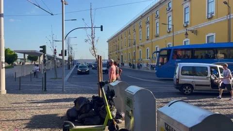E-scooter parked next to underground stainless steel trash bins in Lisbon Stock Footage 220351167