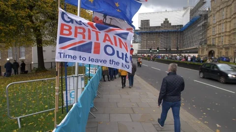 E Walking through flags at Brexit area of Westminster in slow motion 4K Stock Footage 122192515