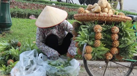 E woman is peeling pineapples Stock Footage 58626197