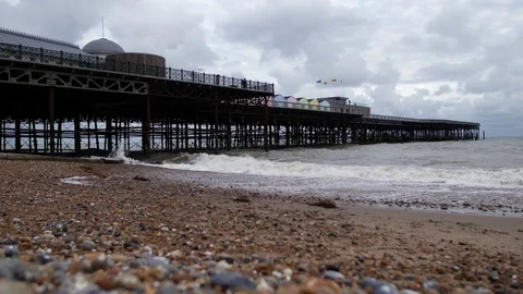 E Zoom into waves next to Hastings pier 4K Stock Footage 123391341