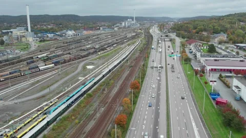 E20 Highway and Savenas train maintenance depot in Gohtenburg, Aerial Pullback Video stock 344563990