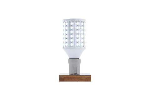 E27 230v screw-cap LED energy-saving lamp on a wooden base isolated on whit.. Stock Photos