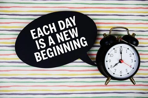 Each day is a new beginning text on speech bubble with alarm clock on color.. Stock Photos