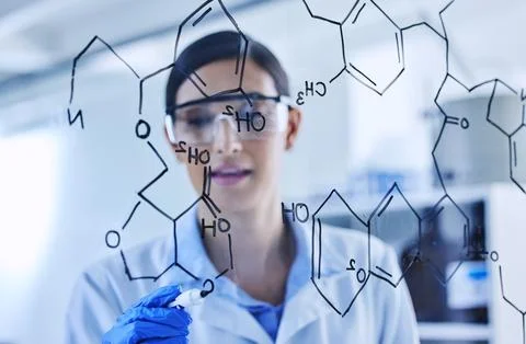 Each line of code connects. an attractive young female scientist working on a Stock Photos