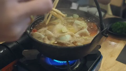 Each members of the dining table used chopsticks to grab food. Stock Footage 163829946