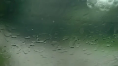 Each slow-motion raindrop trails down the window, momentarily swept away by.. Stock-Footage 255642480